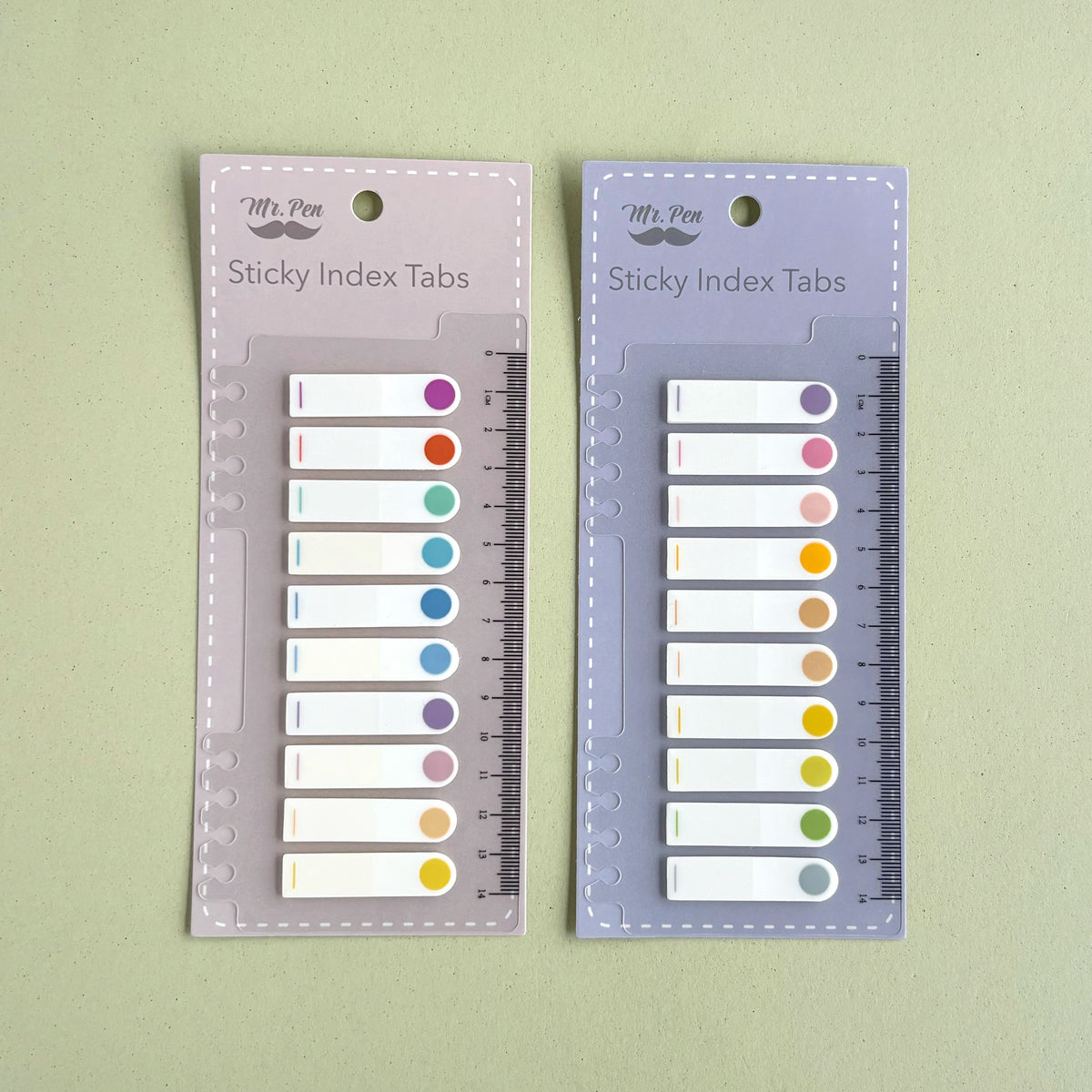 Índices adhesivos con pestaña circular de color y regla integrada.