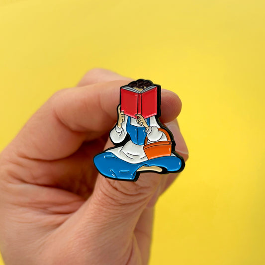 Pin metálico Bella leyendo